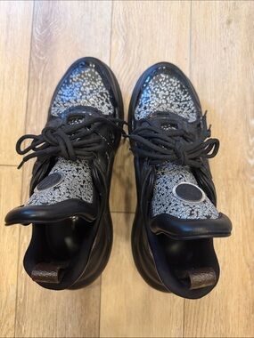 Louis Vuitton women’s sneakers black leather with silver sparkles throughout.